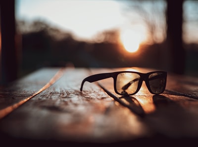 Black sunglasses in brown on the surface of a selective focus on photography
